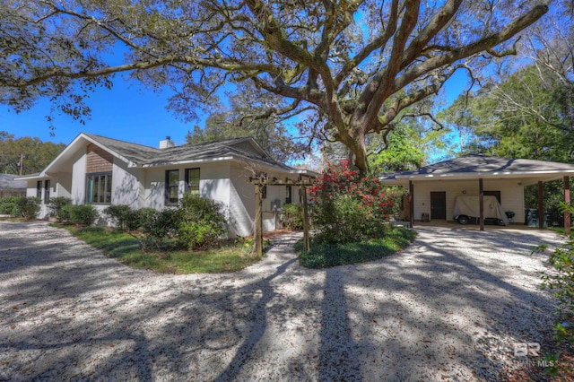 single story home featuring a carport