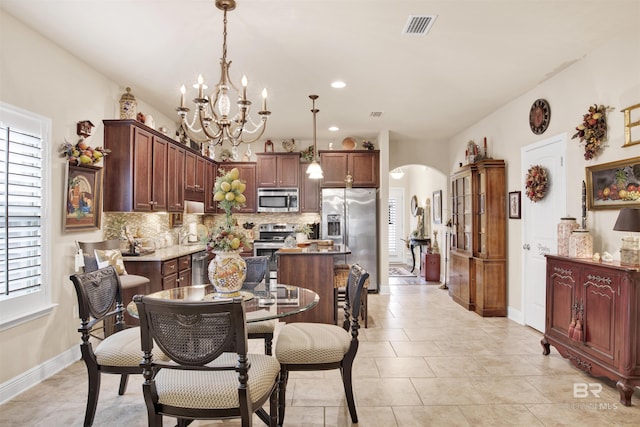 4268 Birkdale St, Gulf Shores, AL 36542 - dining space with arched walkways, plenty of natural light, a chandelier, baseboards, and recessed lighting
