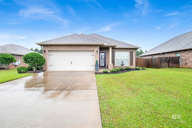 view of front of home with a garage and a front lawn