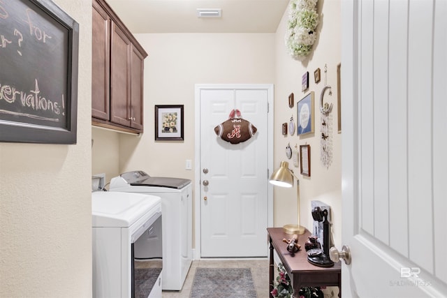 4268 Birkdale St, Gulf Shores, AL 36542 - clothes washing area featuring washing machine and dryer, cabinet space, and light tile patterned floors