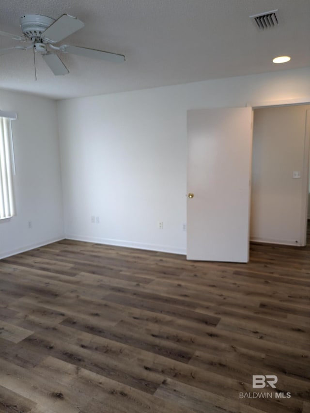 spare room with a ceiling fan, wood finished floors, baseboards, visible vents, and recessed lighting