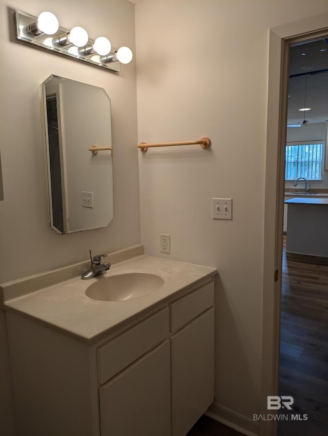 bathroom with wood finished floors and vanity