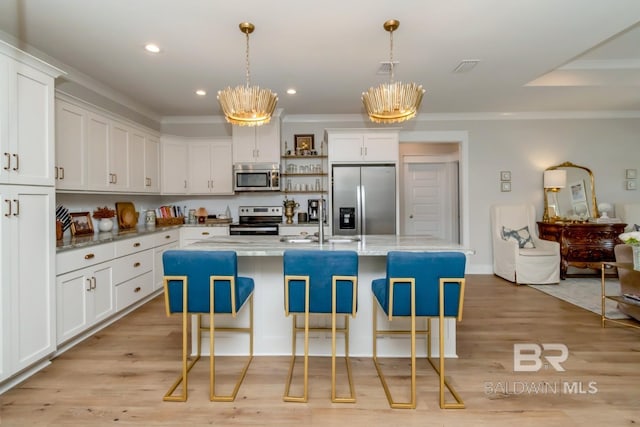 7339 Grissom Dr, Saraland, AL 36571 - kitchen featuring stainless steel appliances, a sink, a chandelier, ornamental molding, and a kitchen bar