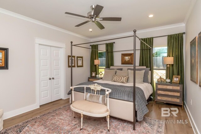 7339 Grissom Dr, Saraland, AL 36571 - bedroom featuring wood finished floors, ornamental molding, baseboards, recessed lighting, and a closet