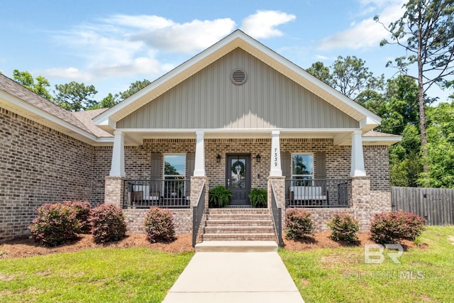 7339 Grissom Dr, Saraland, AL 36571 - view of front facade featuring brick siding, covered porch, and board and batten siding