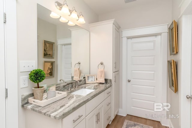 7339 Grissom Dr, Saraland, AL 36571 - bathroom with wood finished floors and vanity