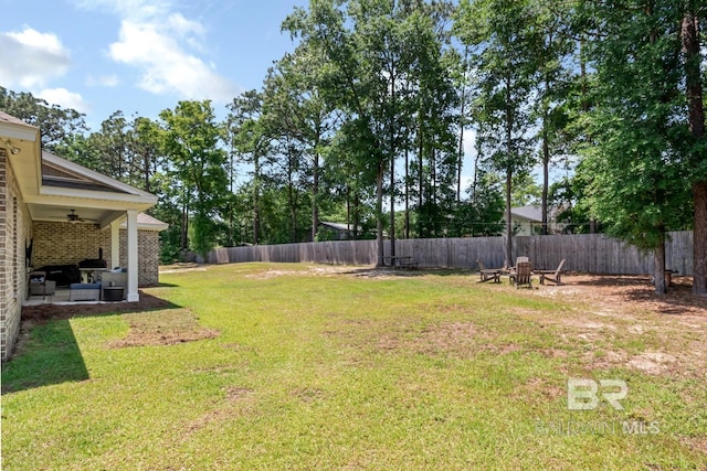 7339 Grissom Dr, Saraland, AL 36571 - view of yard featuring ceiling fan and a fire pit