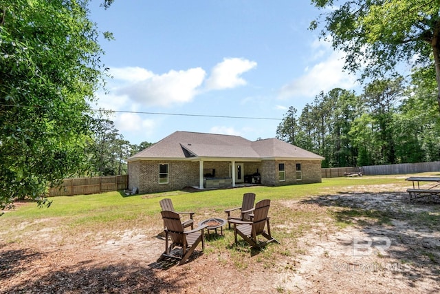 7339 Grissom Dr, Saraland, AL 36571 - rear view of property with a fire pit and brick siding