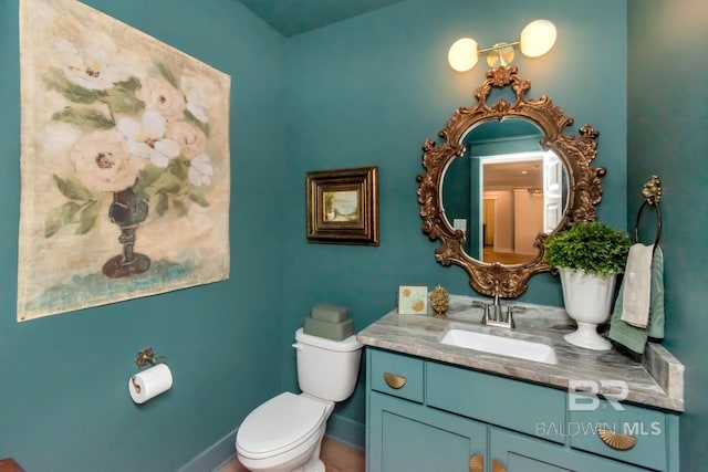 7339 Grissom Dr, Saraland, AL 36571 - half bathroom featuring toilet, vanity, and baseboards