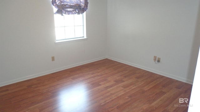 unfurnished room featuring dark wood-type flooring