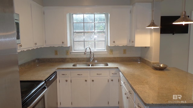 kitchen featuring white cabinetry, hanging light fixtures, and stainless steel appliances