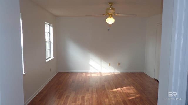 empty room with dark hardwood / wood-style floors and ceiling fan