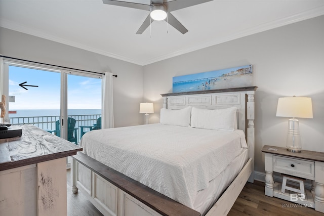 bedroom featuring crown molding, access to outside, dark wood-style floors, and a water view