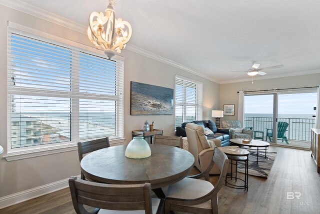 dining room featuring baseboards, dark wood-style floors, and ornamental molding