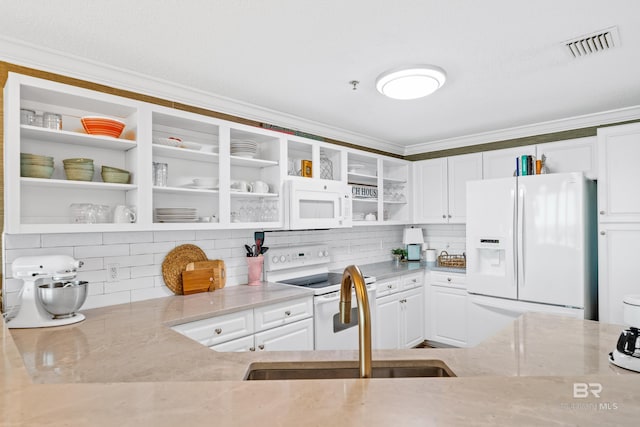 kitchen featuring white cabinetry, sink, light stone countertops, backsplash, and white appliances