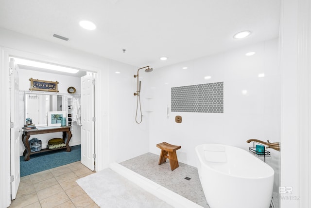 bathroom with tile patterned floors and shower with separate bathtub