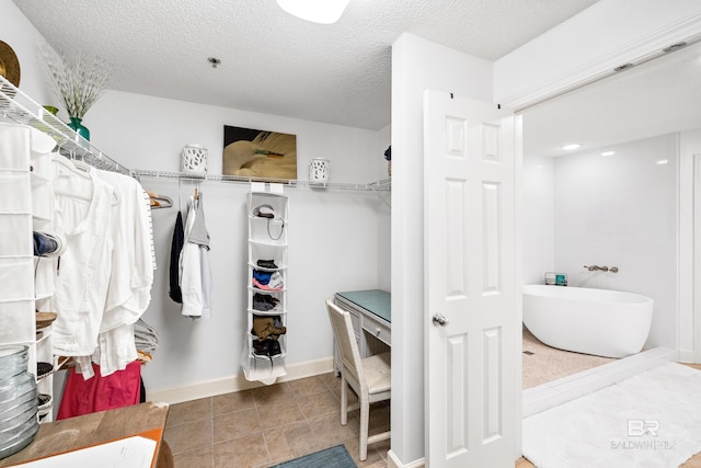 spacious closet with tile patterned flooring