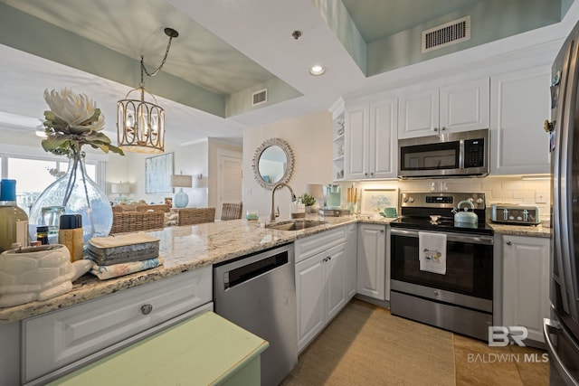 kitchen featuring white cabinetry, kitchen peninsula, stainless steel appliances, and sink