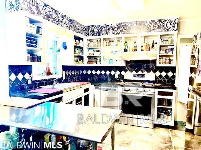 bar with decorative backsplash and stainless steel gas range