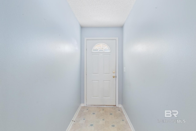 doorway featuring a textured ceiling