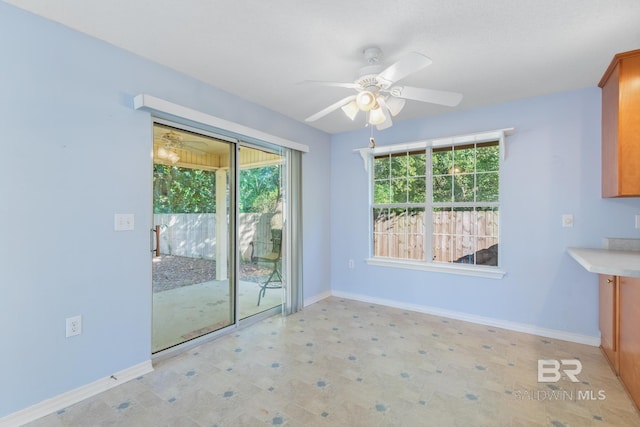 unfurnished dining area featuring ceiling fan