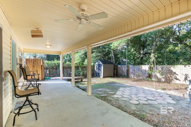 view of patio / terrace with ceiling fan and a storage unit