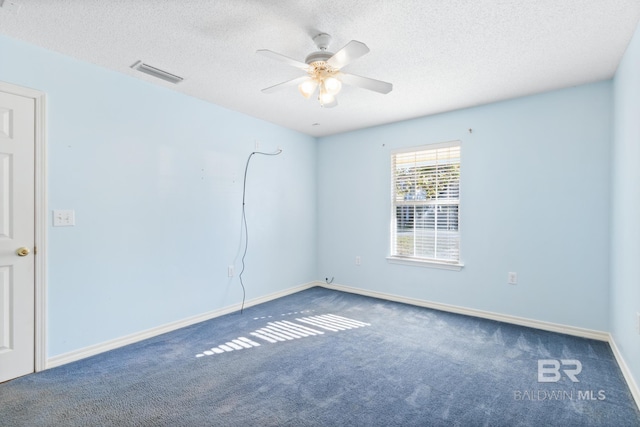 carpeted spare room with a textured ceiling and ceiling fan