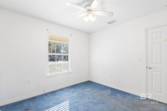 carpeted spare room featuring ceiling fan