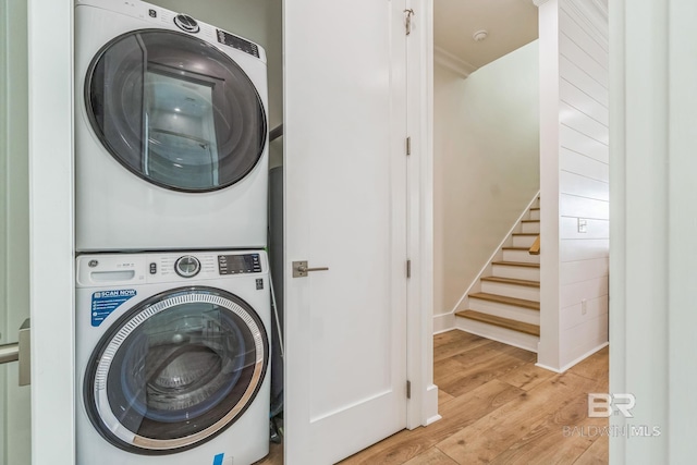 1050 W Beach Blvd Unit E, Gulf Shores, AL 36542 - laundry room featuring stacked washer and clothes dryer and light wood-style floors