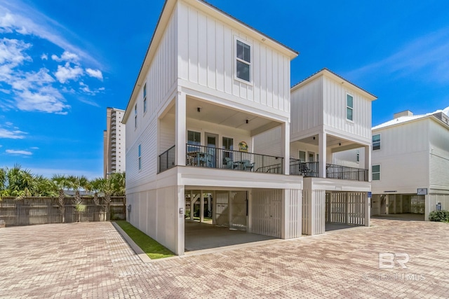 1050 W Beach Blvd Unit E, Gulf Shores, AL 36542 - rear view of house with board and batten siding