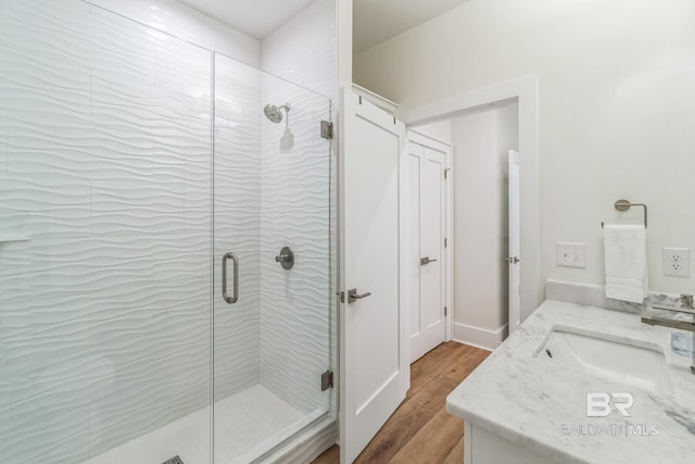 1050 W Beach Blvd Unit E, Gulf Shores, AL 36542 - bathroom featuring wood finished floors, vanity, and a shower stall