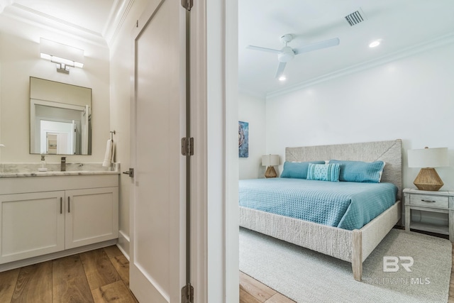 1050 W Beach Blvd Unit E, Gulf Shores, AL 36542 - bedroom with crown molding, wood finished floors, ensuite bathroom, and recessed lighting