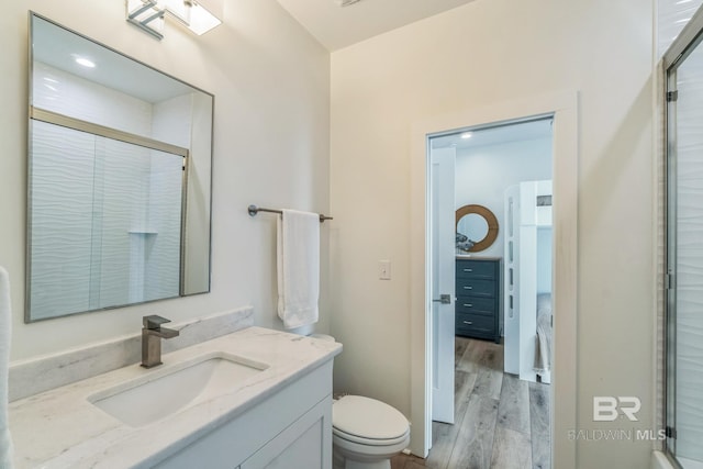 1050 W Beach Blvd Unit E, Gulf Shores, AL 36542 - bathroom featuring wood finished floors, vanity, and a stall shower