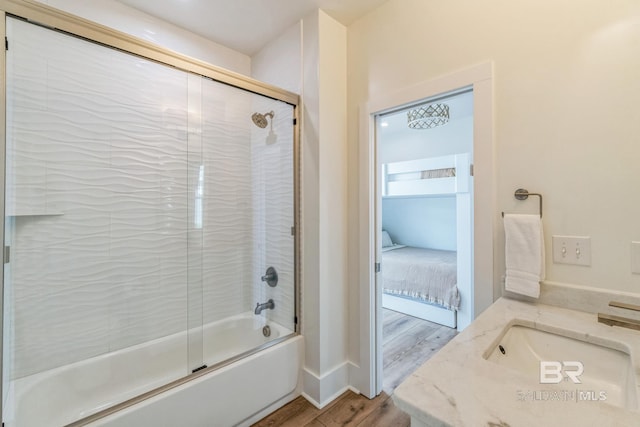 1050 W Beach Blvd Unit E, Gulf Shores, AL 36542 - bathroom featuring wood finished floors, shower / bath combination with glass door, and vanity