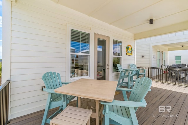 1050 W Beach Blvd Unit E, Gulf Shores, AL 36542 - wooden deck featuring outdoor dining space