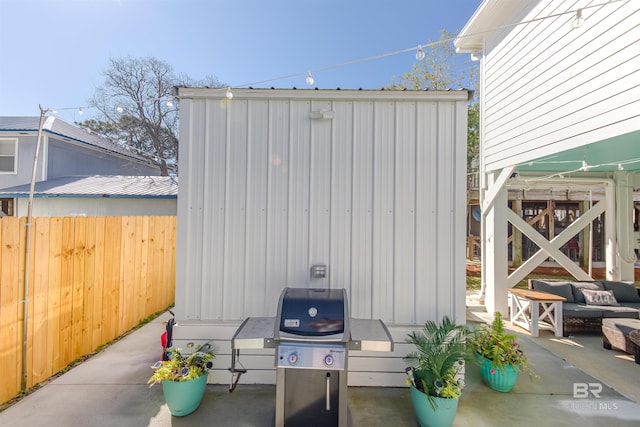 view of outdoor structure with fence and an outdoor living space