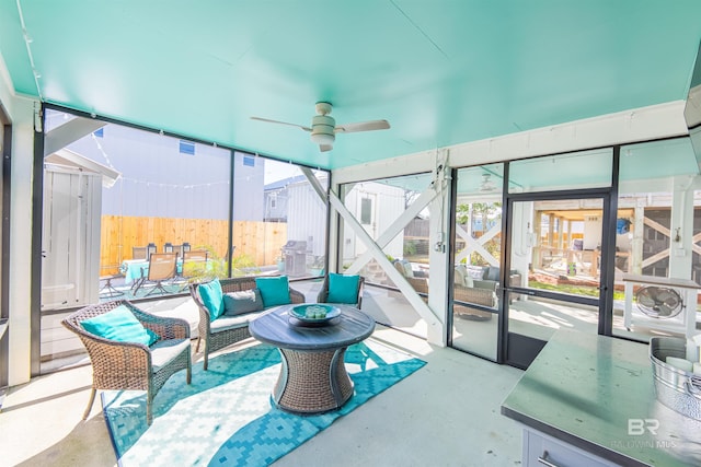 sunroom / solarium with a ceiling fan