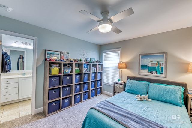 bedroom featuring ensuite bath, carpet, baseboards, and a ceiling fan