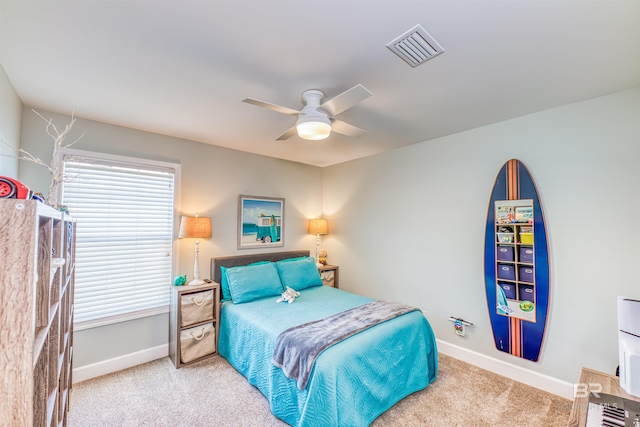 bedroom featuring carpet, multiple windows, visible vents, and baseboards