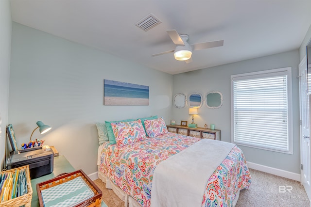 carpeted bedroom with visible vents, ceiling fan, and baseboards