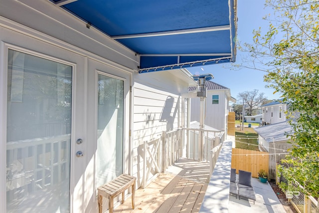 view of patio featuring fence and a deck