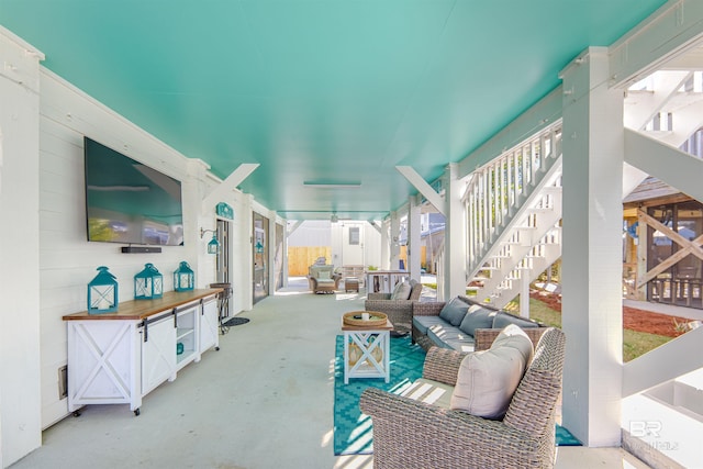 view of patio with stairway and an outdoor living space