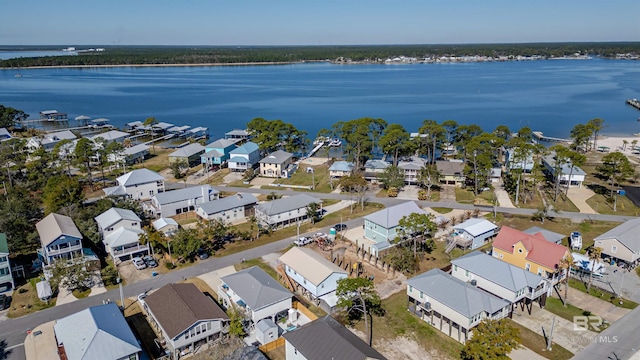 birds eye view of property with a water view and a residential view