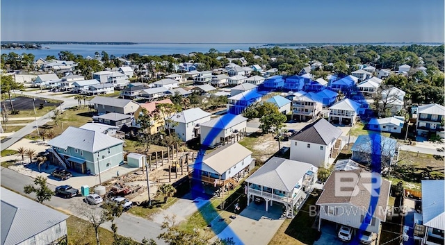 drone / aerial view featuring a water view and a residential view