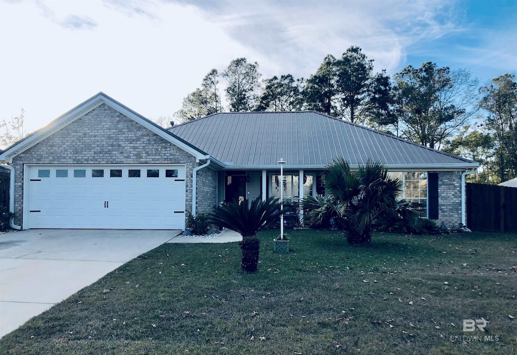 ranch-style home featuring a garage and a front lawn