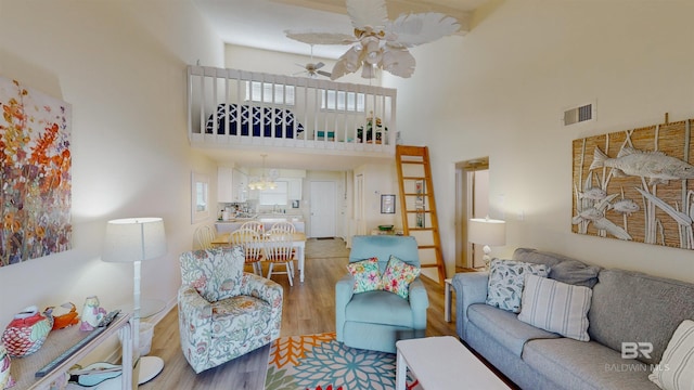 28835 Perdido Beach Blvd Unit 309, Orange Beach, AL 36561 - living room featuring a high ceiling, ceiling fan, and wood finished floors