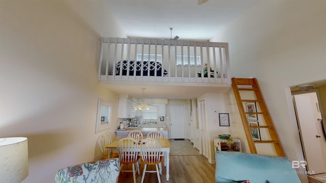 28835 Perdido Beach Blvd Unit 309, Orange Beach, AL 36561 - living area with light wood finished floors, a high ceiling, and a chandelier
