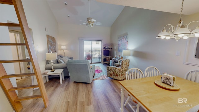 28835 Perdido Beach Blvd Unit 309, Orange Beach, AL 36561 - dining room featuring light wood-style floors, high vaulted ceiling, a chandelier, and a ceiling fan