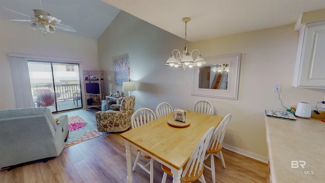 28835 Perdido Beach Blvd Unit 309, Orange Beach, AL 36561 - dining area featuring a chandelier, light wood-type flooring, baseboards, and high vaulted ceiling