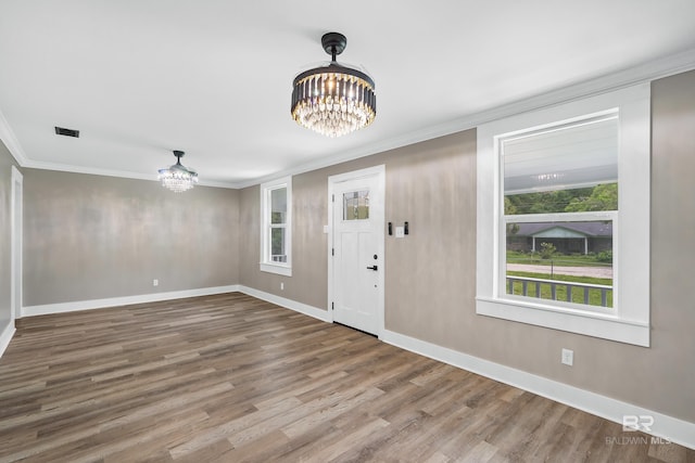 1716 Bryan Ave, Mobile, AL 36605 - entryway with a chandelier, ornamental molding, wood finished floors, and baseboards